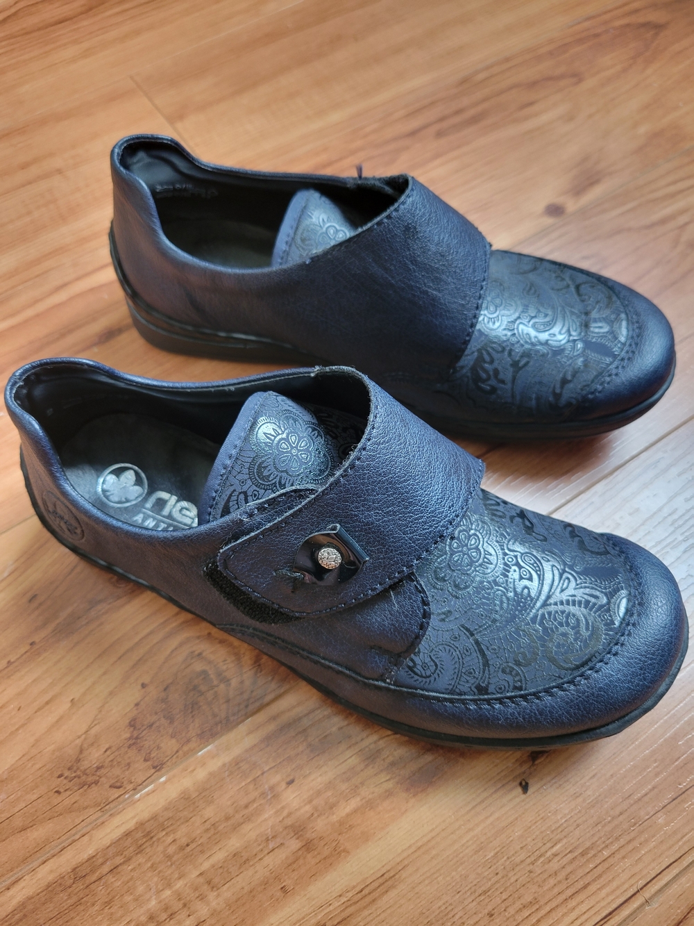 Rieker Black Embossed Floral Hook-and-Loop Slip-Ons
